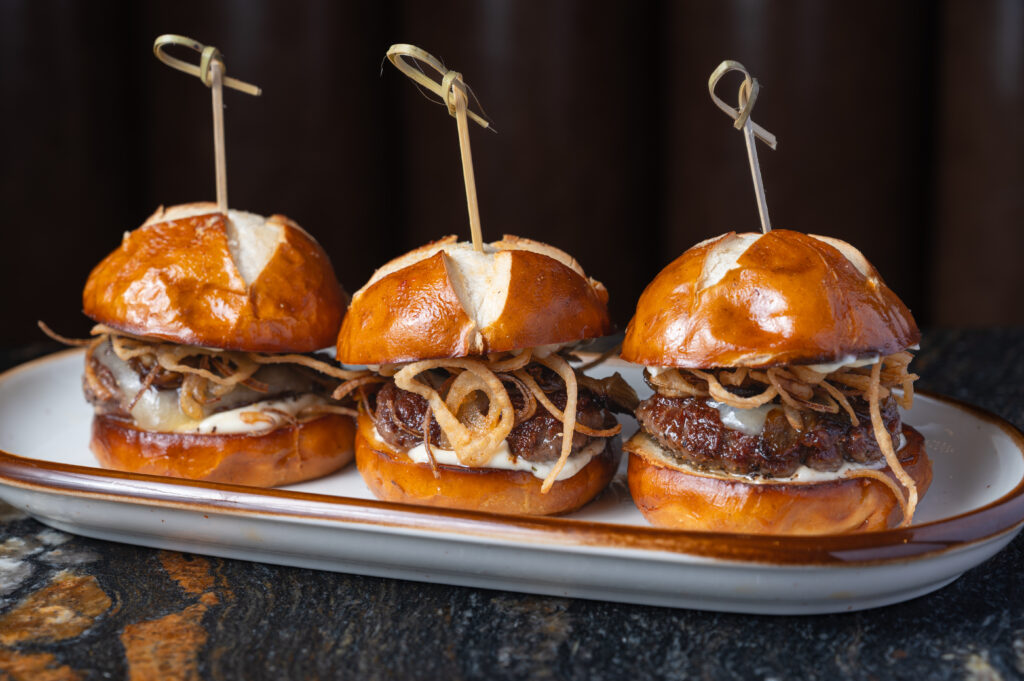 Mini beef sliders on brioche buns with crispy onion straws at The Bridewell Tavern