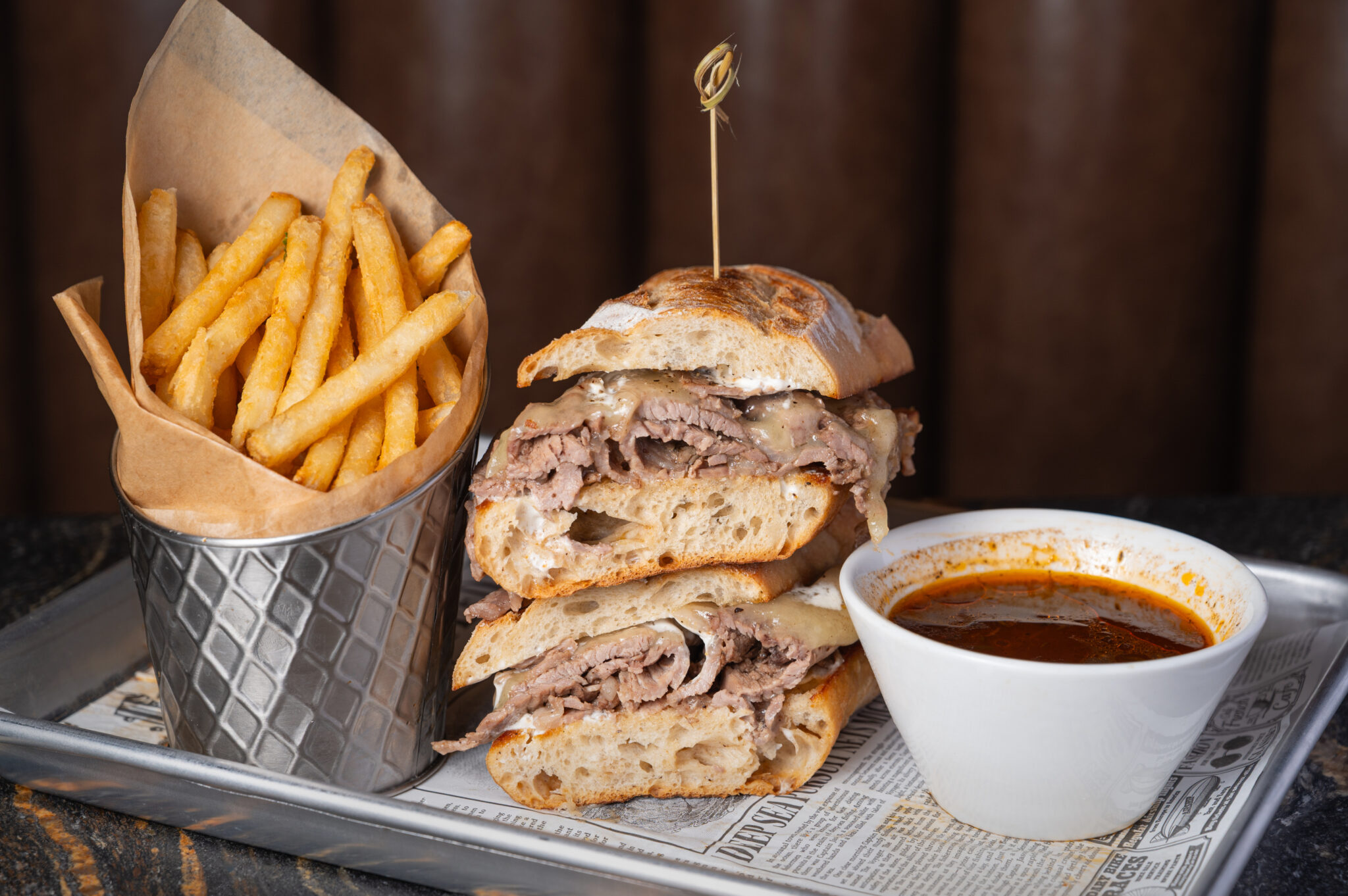 Slow-roasted beef sandwich with au jus gravy and crispy fries at The Bridewell Tavern